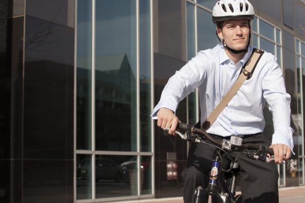 Muž na kole u kancelářské budovy